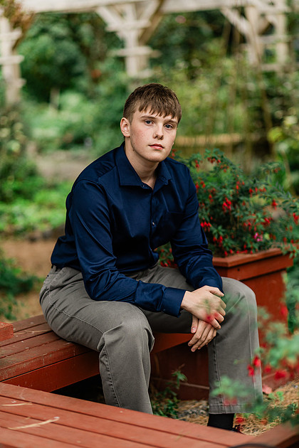 senior boy in a field and garden