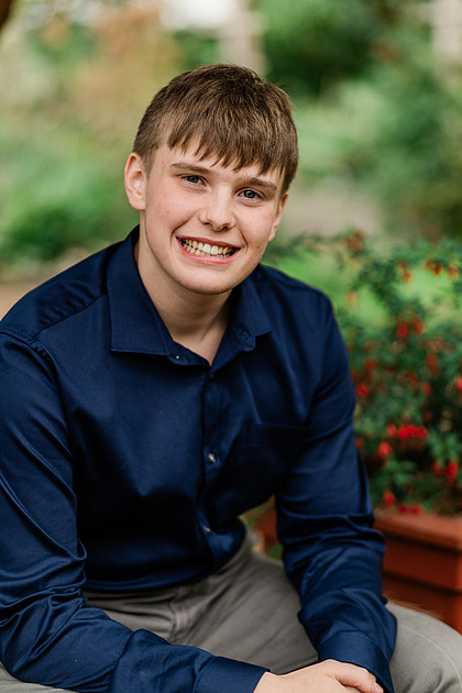 senior boy in a field and garden