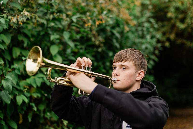 senior boy in a field and garden