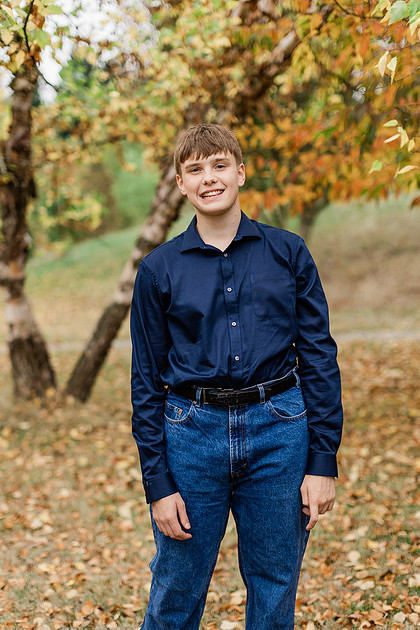 senior boy in a field and garden