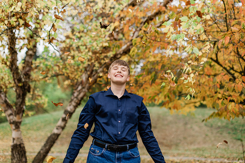 senior boy in a field and garden