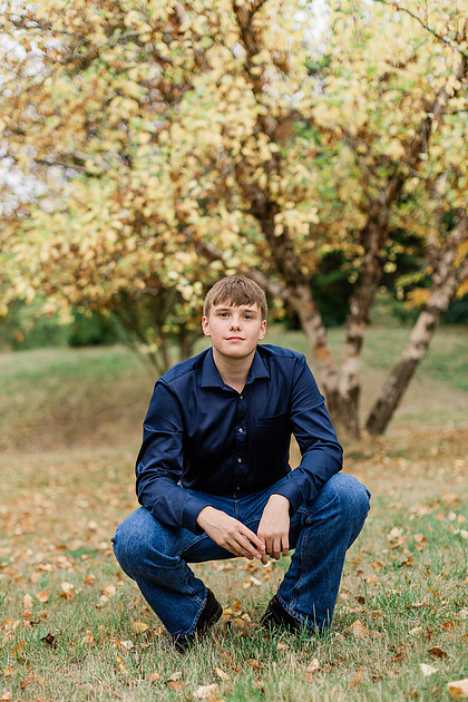 senior boy in a field and garden