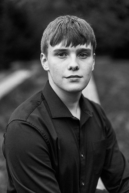 senior boy in a field and garden