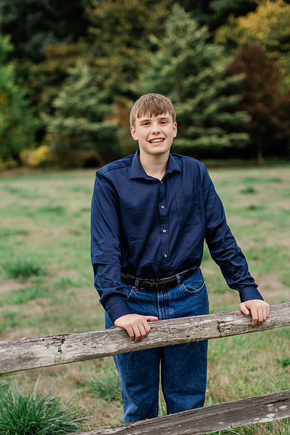 senior boy in a field and garden
