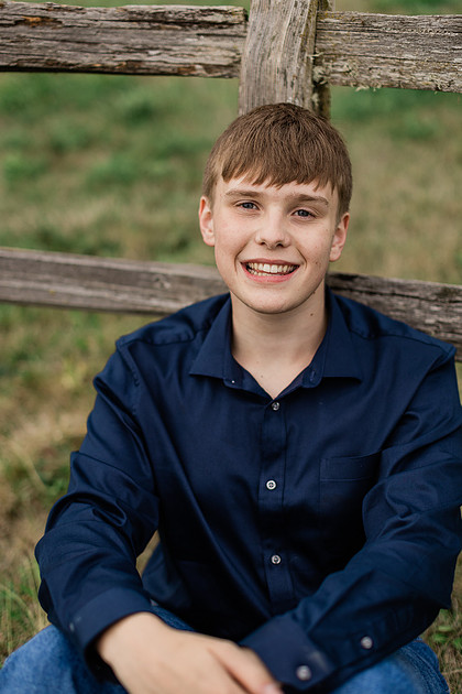senior boy in a field and garden