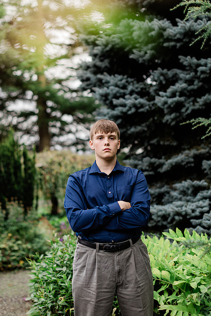 senior boy in a field and garden