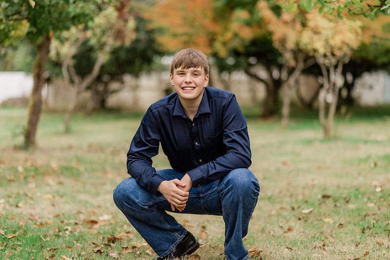 senior boy in a field and garden