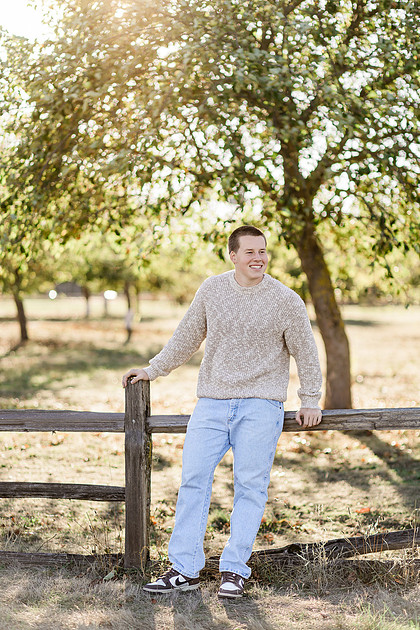 Senior boy portraits by the river and in a field