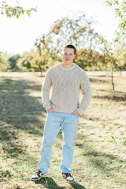 Senior boy portraits by the river and in a field