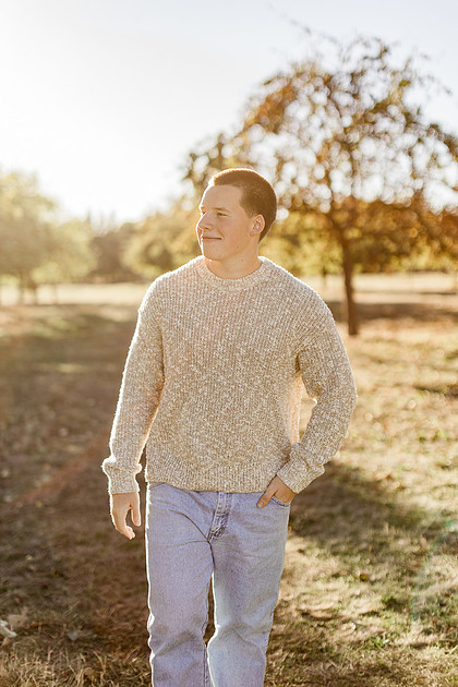 Senior boy portraits by the river and in a field