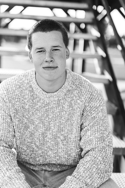 Senior boy portraits by the river and in a field