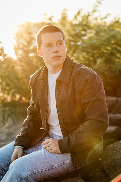 Senior boy portraits by the river and in a field