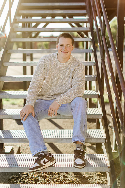 Senior boy portraits by the river and in a field