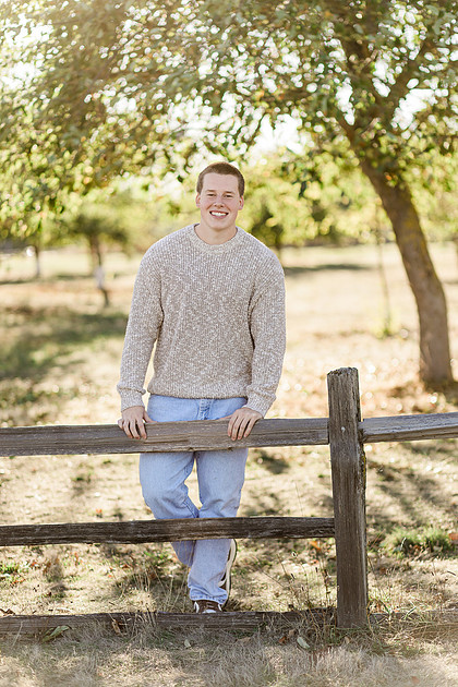Senior boy portraits by the river and in a field