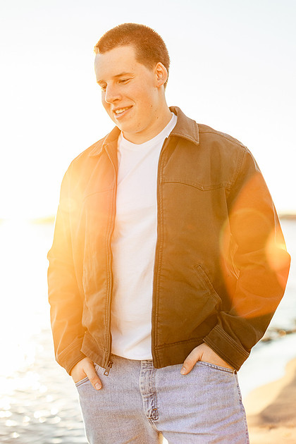 Senior boy portraits by the river and in a field