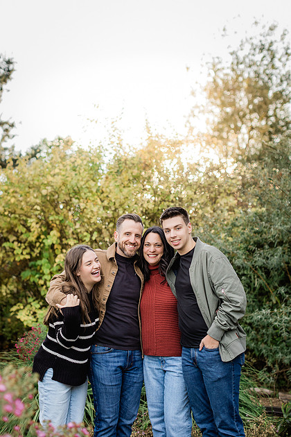 Family with teens in a garden during the Fall season 