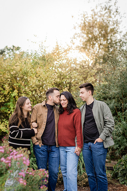 Family with teens in a garden during the Fall season 