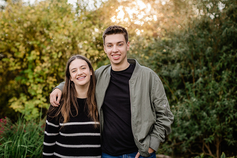 Family of 4 with teens in a garden during the fall season