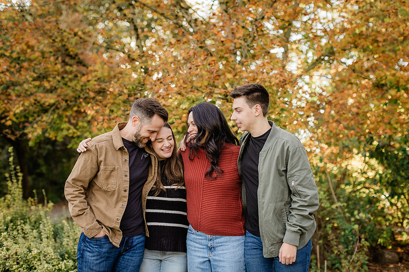 Family of 4 with teens in a garden during the fall season