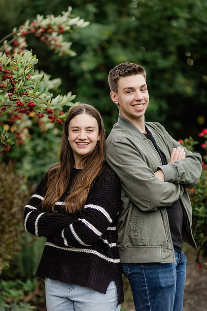 Family of 4 with teens in a garden during the fall season