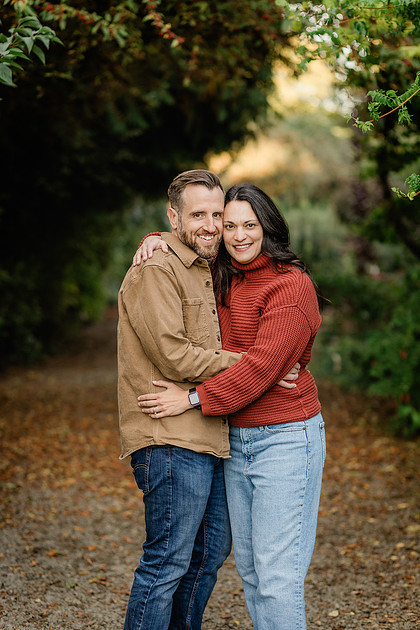 Family of 4 with teens in a garden during the fall season