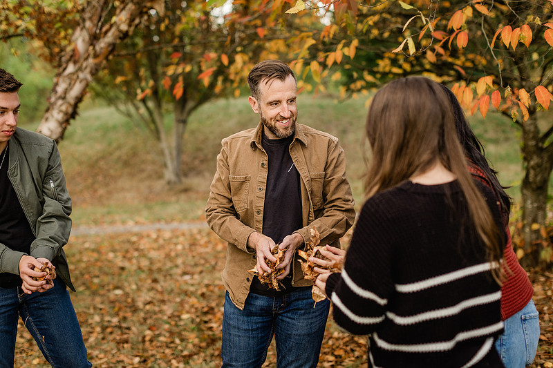 Family of 4 with teens in a garden during the fall season
