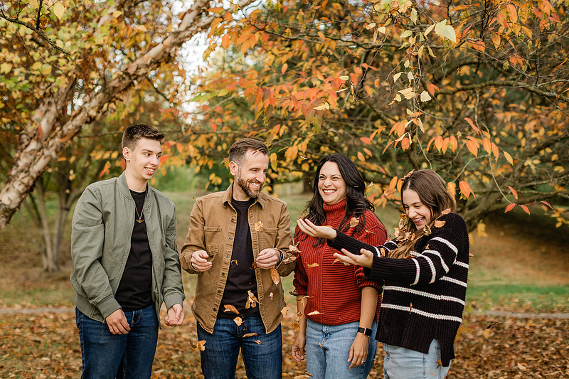 Family of 4 with teens in a garden during the fall season