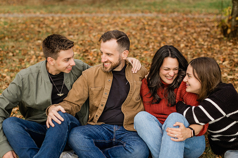 Family of 4 with teens in a garden during the fall season