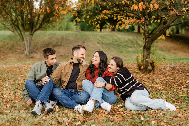 Family of 4 with teens in a garden during the fall season
