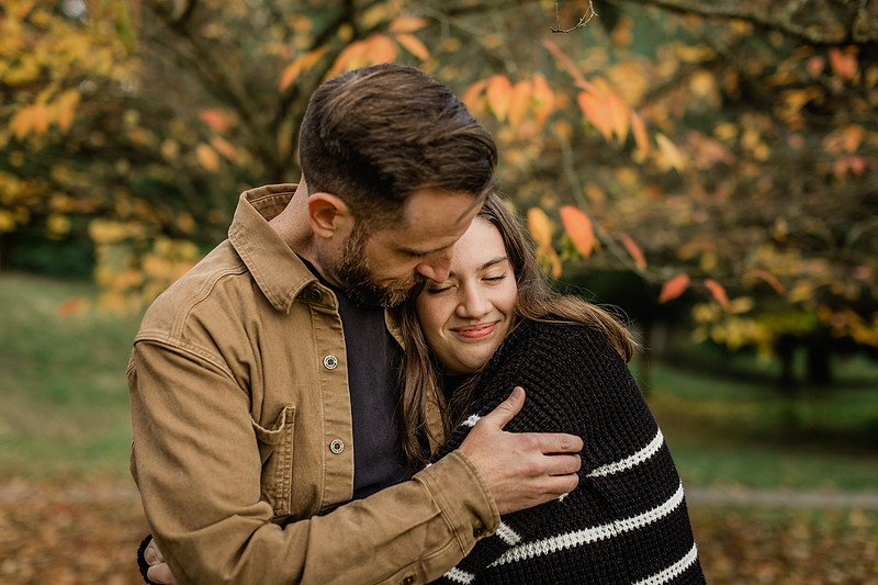 Family of 4 with teens in a garden during the fall season
