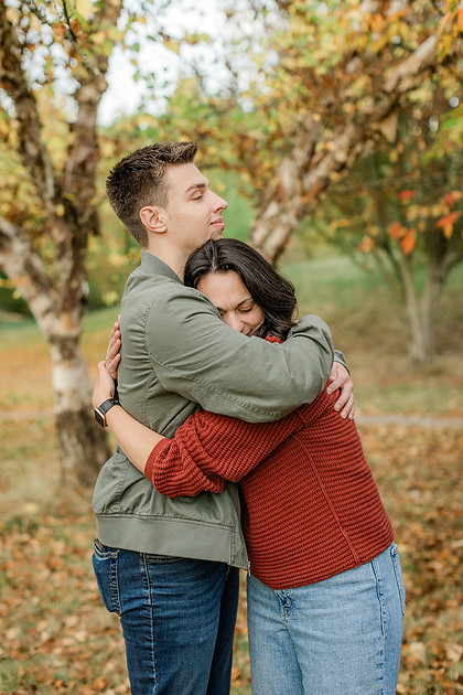 Family of 4 with teens in a garden during the fall season