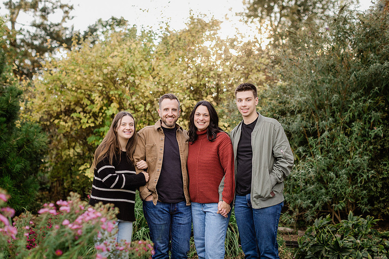 Family with teens in a garden during the Fall season 