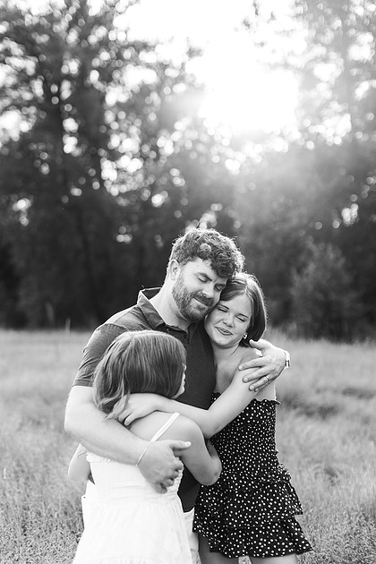 Portrait of a Family of 4 standing in a field at Daybreak Park in Battleground WA