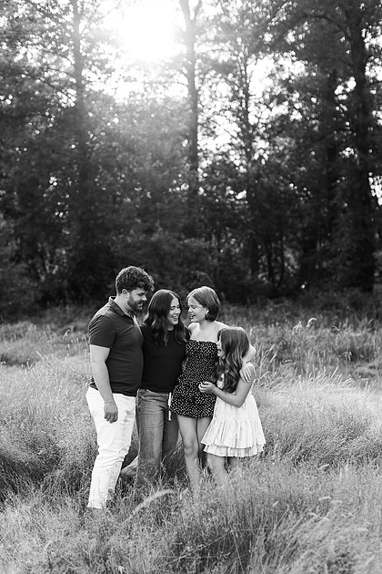 Portrait of a Family of 4 standing in a field at Daybreak Park in Battleground WA