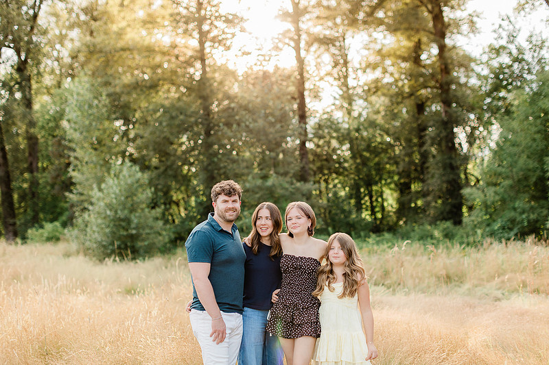 Portrait of a Family of 4 standing in a field at Daybreak Park in Battleground WA