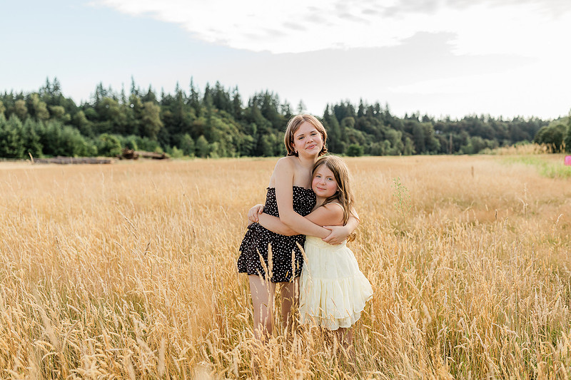 Portrait of a Family of 4 standing in a field at Daybreak Park in Battleground WA