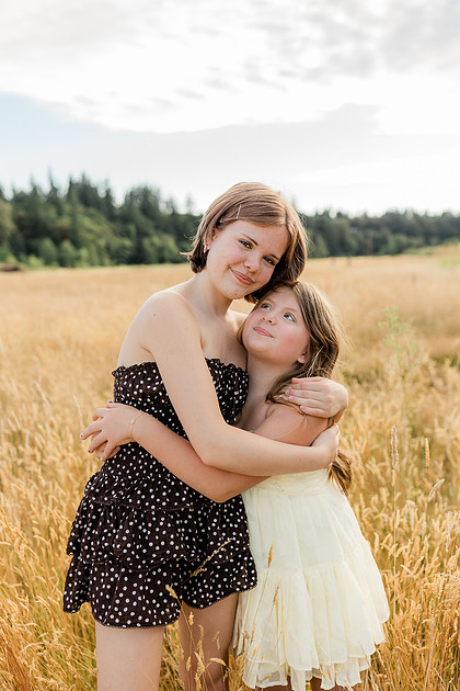 Portrait of a Family of 4 standing in a field at Daybreak Park in Battleground WA
