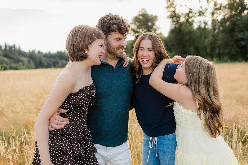 Portrait of a Family of 4 standing in a field at Daybreak Park in Battleground WA