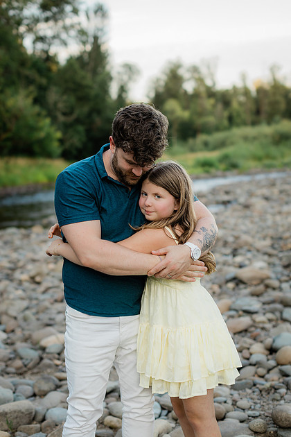 Portrait of a Family of 4 standing in a field at Daybreak Park in Battleground WA