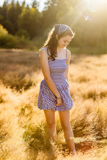 2 female friends playing in a field with trees