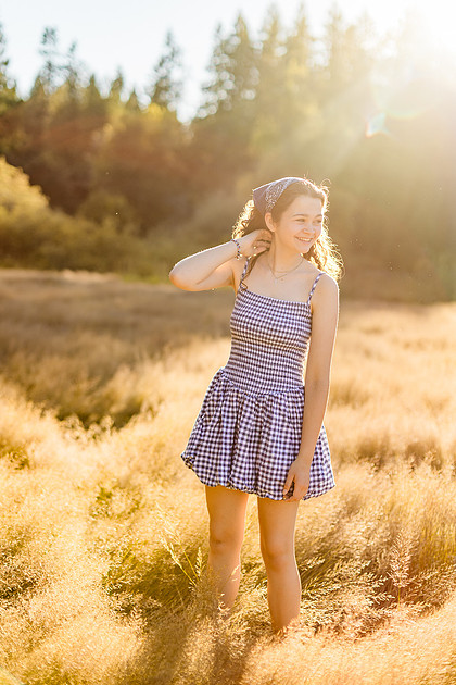 2 female friends playing in a field with trees