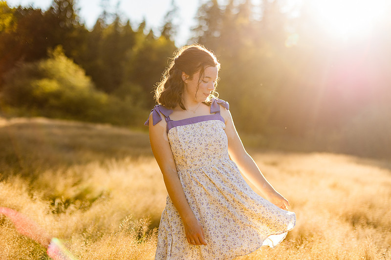 2 female friends playing in a field with trees