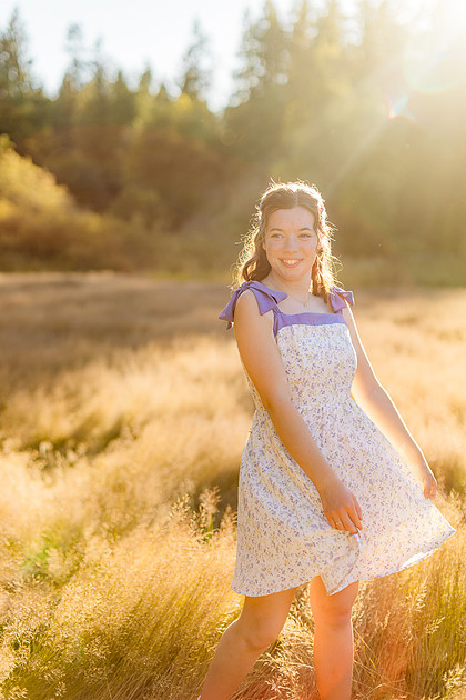 2 female friends playing in a field with trees