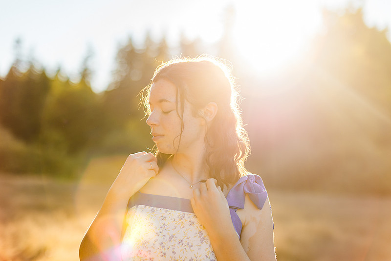 2 female friends playing in a field with trees