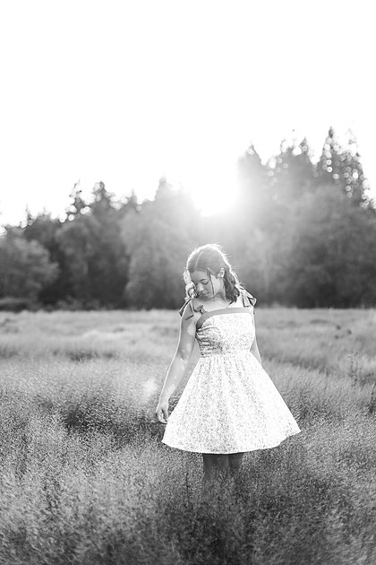 2 female friends playing in a field with trees