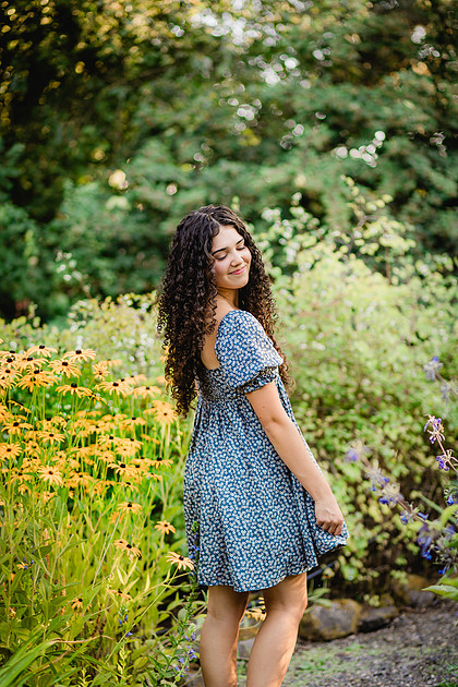 Senior girl wearing a white dress and blue dress in a field and garden in Vancouver, WA