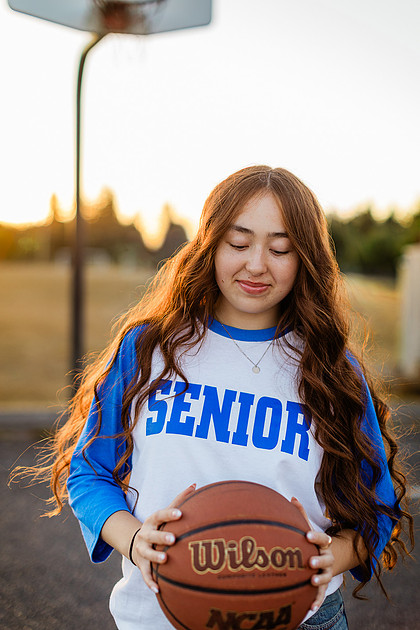 Girl senior athlete on a basketball court and by the river