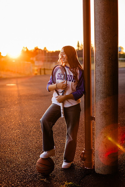 Girl senior athlete on a basketball court and by the river