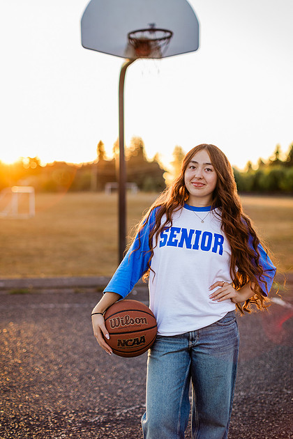 Girl senior athlete on a basketball court and by the river