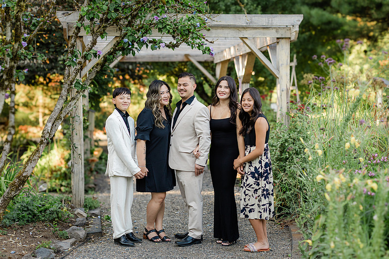 formal portraits of family of 5 in a garden